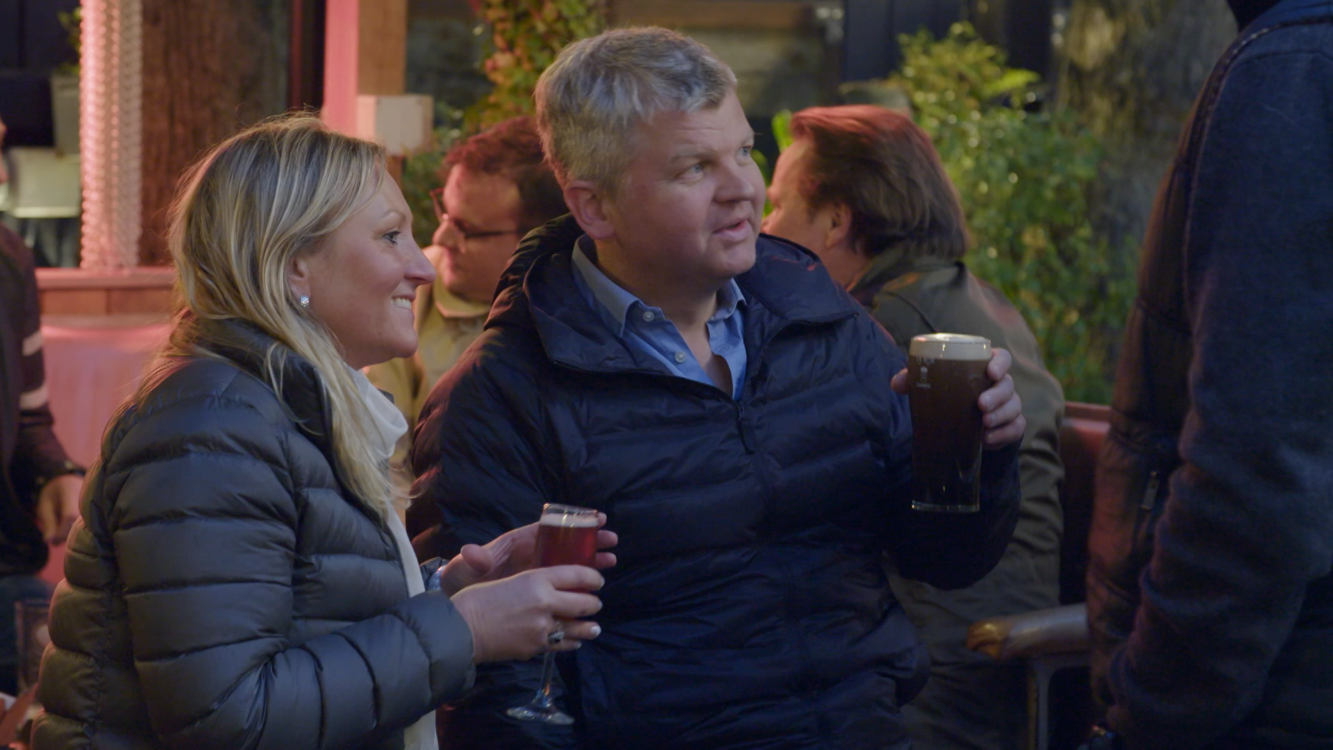 Adrian Chiles and a woman with beer
