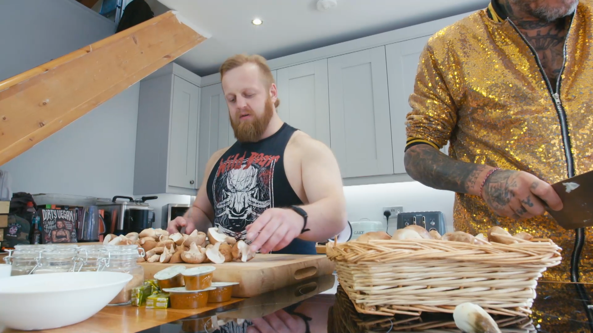 A wrestler chopping mushrooms in a kitchen
